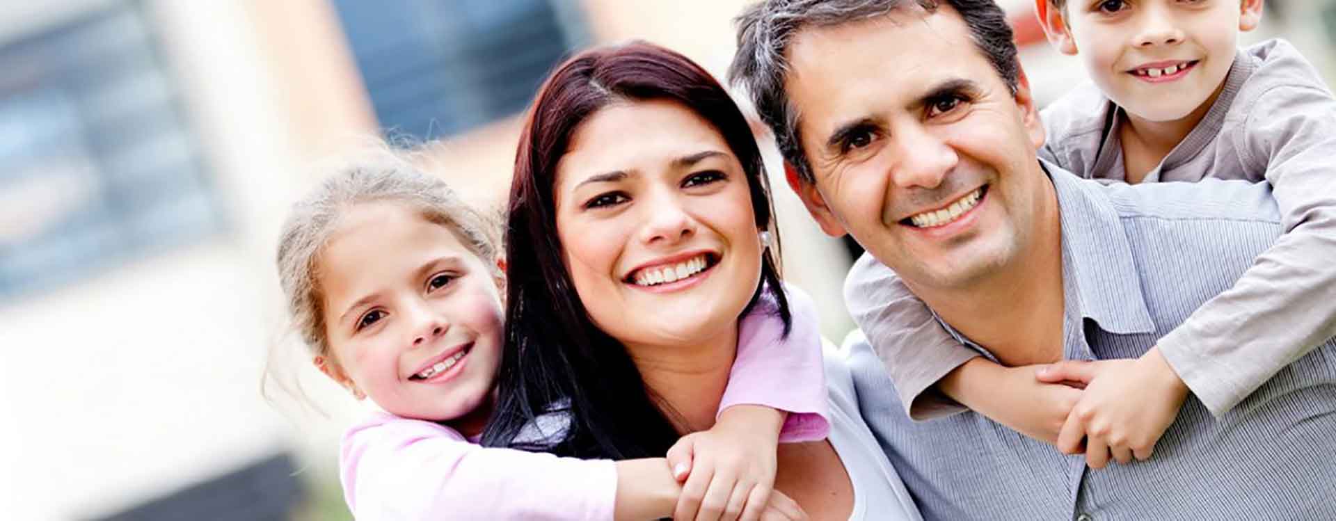 Smiling family — mother, father and two children